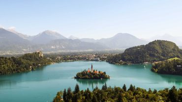 beautiful island with trees and buildings on the lake