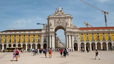 people walking near the praca do comercio plaza